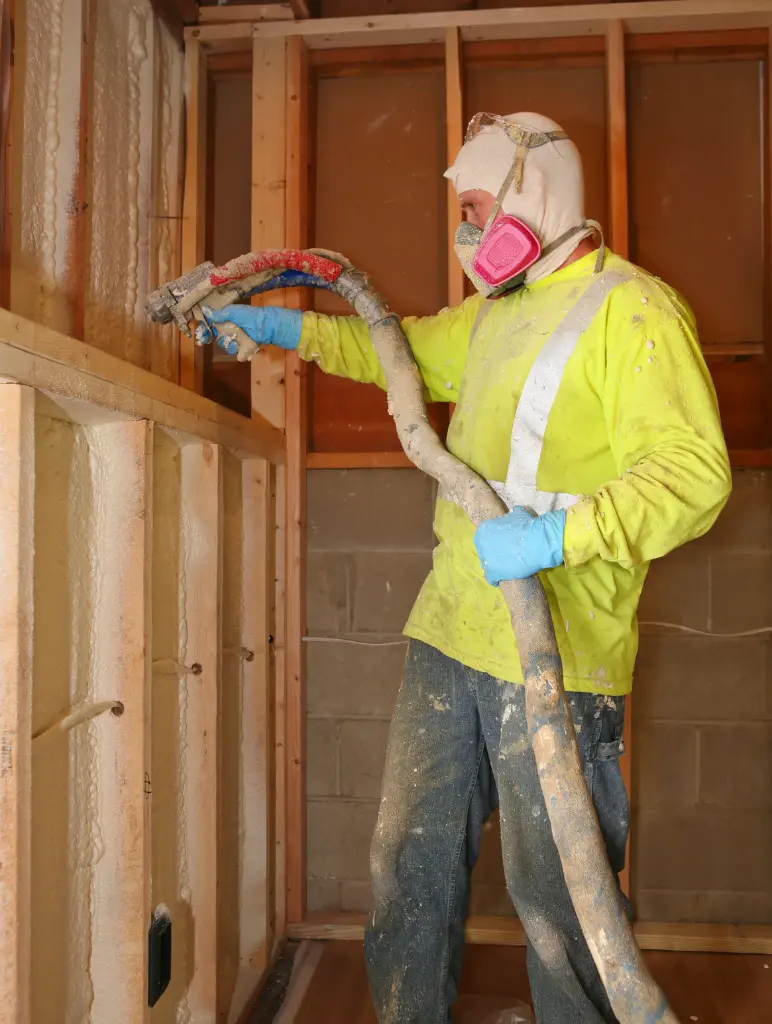 Professional installer spraying foam insulation in a residential building in Fort Worth.